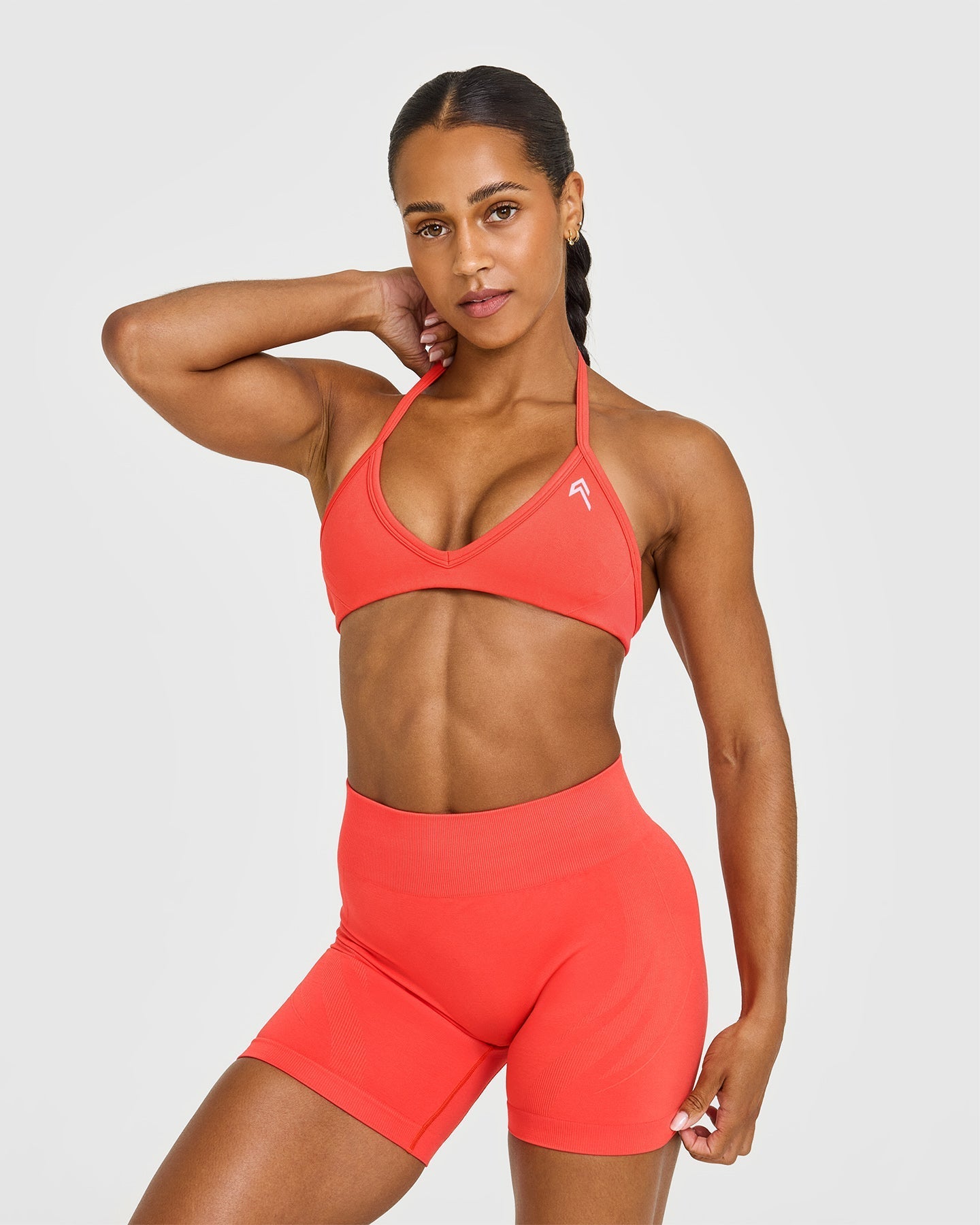 EnhanceLift™ Seamless Minimal Halter Neck Bralette with White Logo | Charged Coral