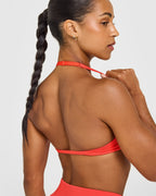 EnhanceLift™ Seamless Minimal Halter Neck Bralette with White Logo | Charged Coral