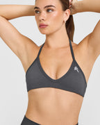 EnhanceLift™ Seamless Minimal Halter Neck Bralette with White Logo | Coal