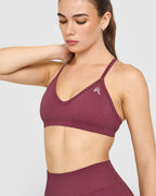 EnhanceLift™ Seamless Strappy Sports Bra with White Logo | Burnt Maroon