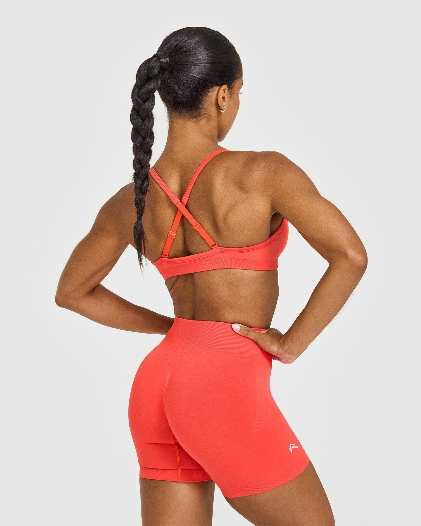 EnhanceLift™ Seamless Strappy Sports Bra with White Logo | Charged Coral
