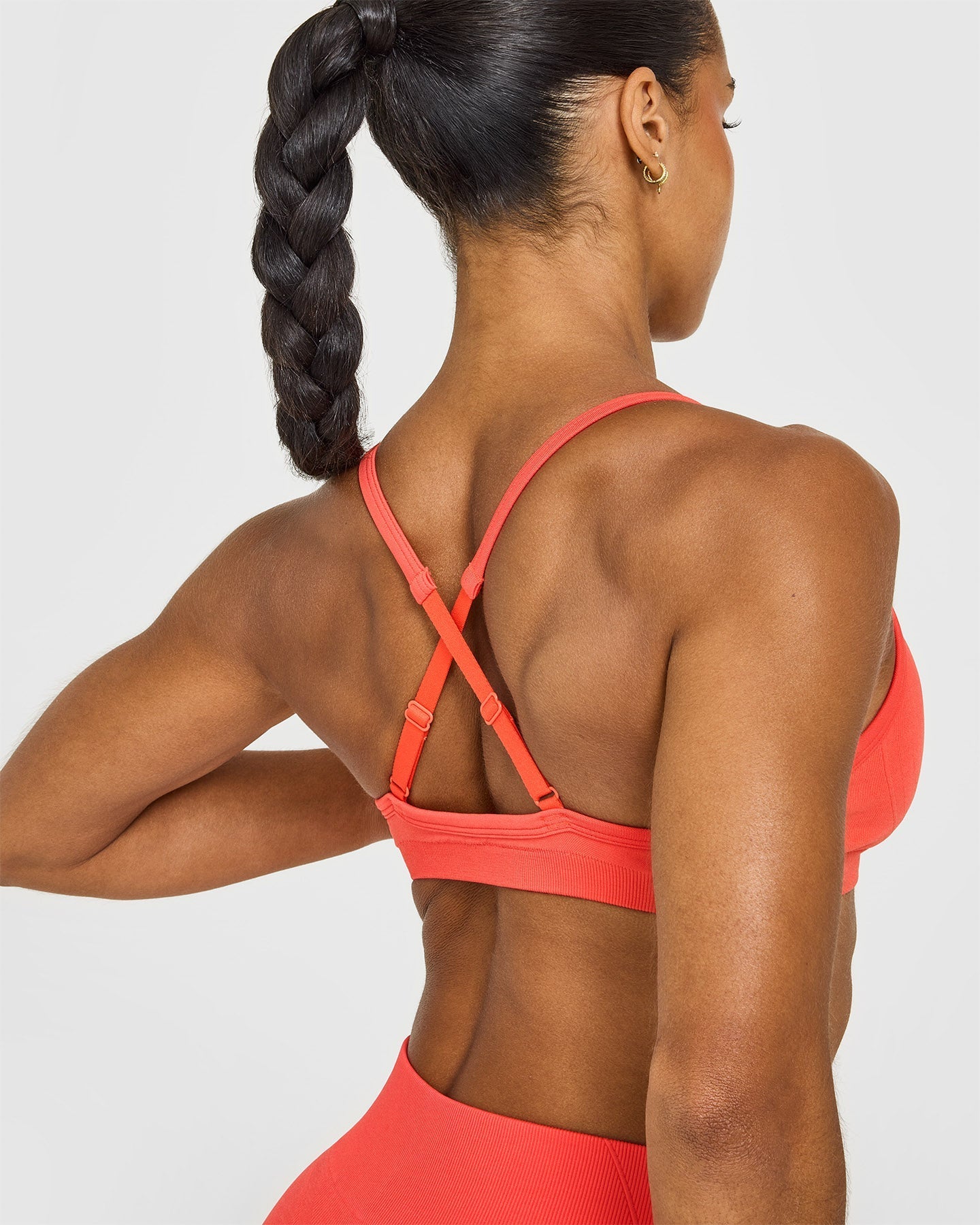 EnhanceLift™ Seamless Strappy Sports Bra with White Logo | Charged Coral