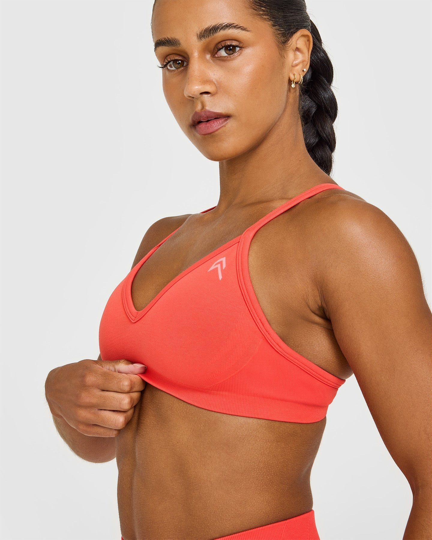 EnhanceLift™ Seamless Strappy Sports Bra with White Logo | Charged Coral