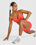 EnhanceLift™ Seamless Strappy Sports Bra with White Logo | Charged Coral