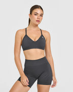 EnhanceLift™ Seamless Strappy Sports Bra with White Logo | Coal