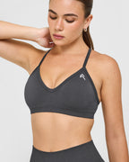 EnhanceLift™ Seamless Strappy Sports Bra with White Logo | Coal