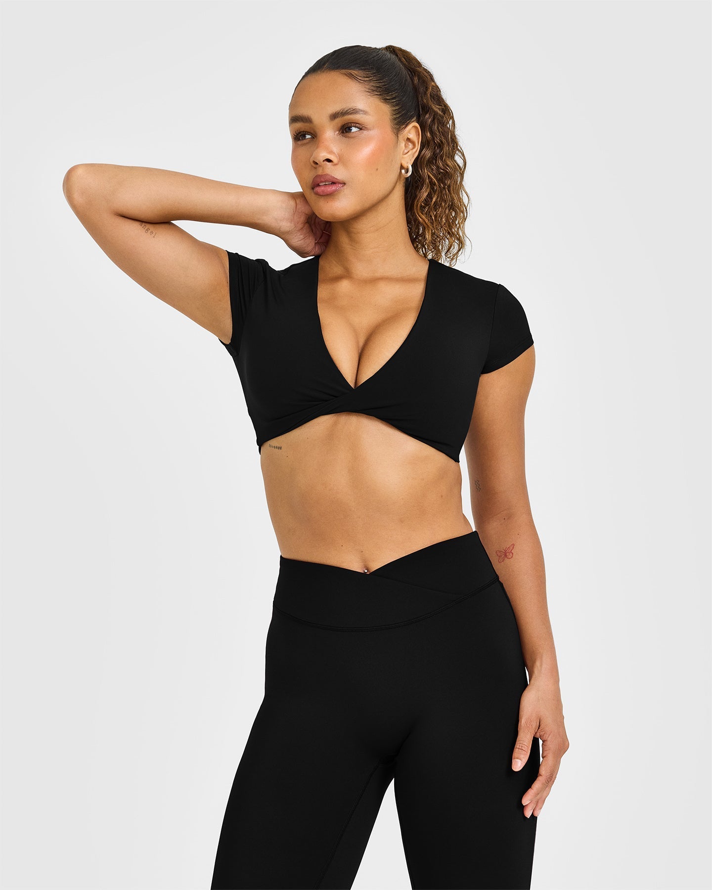 Unified Twist Front Short Sleeve Crop Top White Logo | Black
