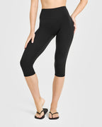 SoftMotion™ High Waisted Capri Leggings with White Logo | Black