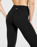 SoftMotion™ High Waisted Capri Leggings with White Logo | Black